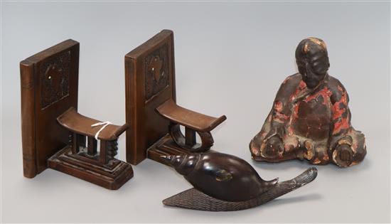 A 19th century Chinese carved snail, a lacquered figure and a pair of carved African bookends